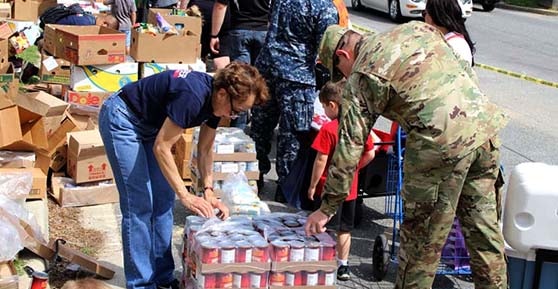 veteran and other people at food distribution event