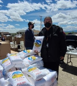 a food pantry volunteer on the Wind River Indian Reservation holding a bag of flour