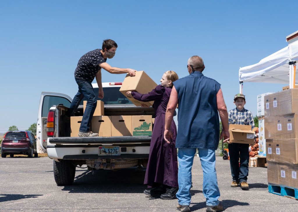 food bank volunteers loading a pickup truck with boxes