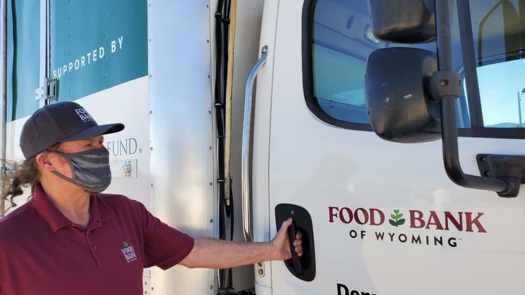 Food bank truck driver about to get into a delivery truck