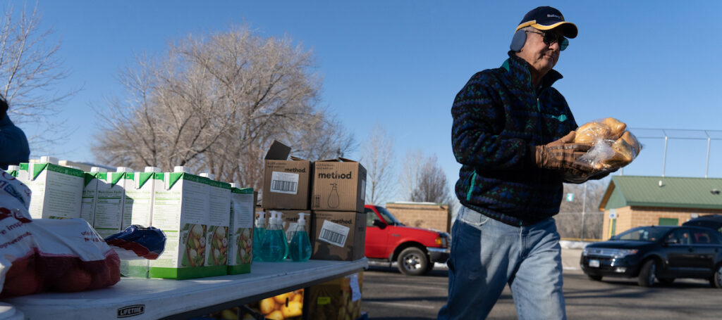 A food bank volunteer working at a mobile pantry site.
