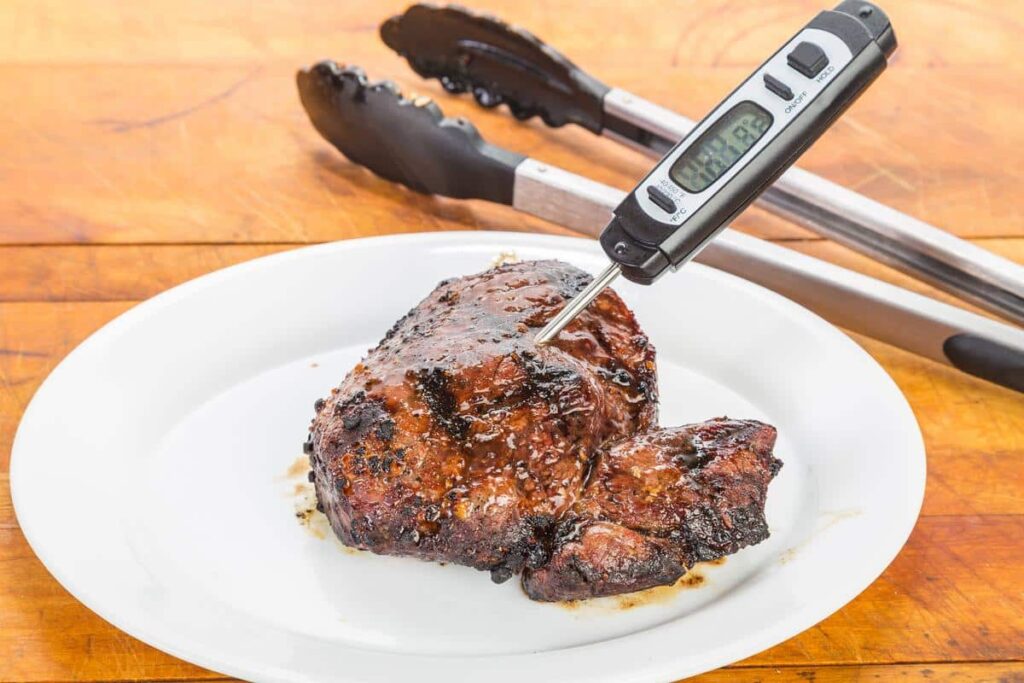 Steak with a thermometer in it.