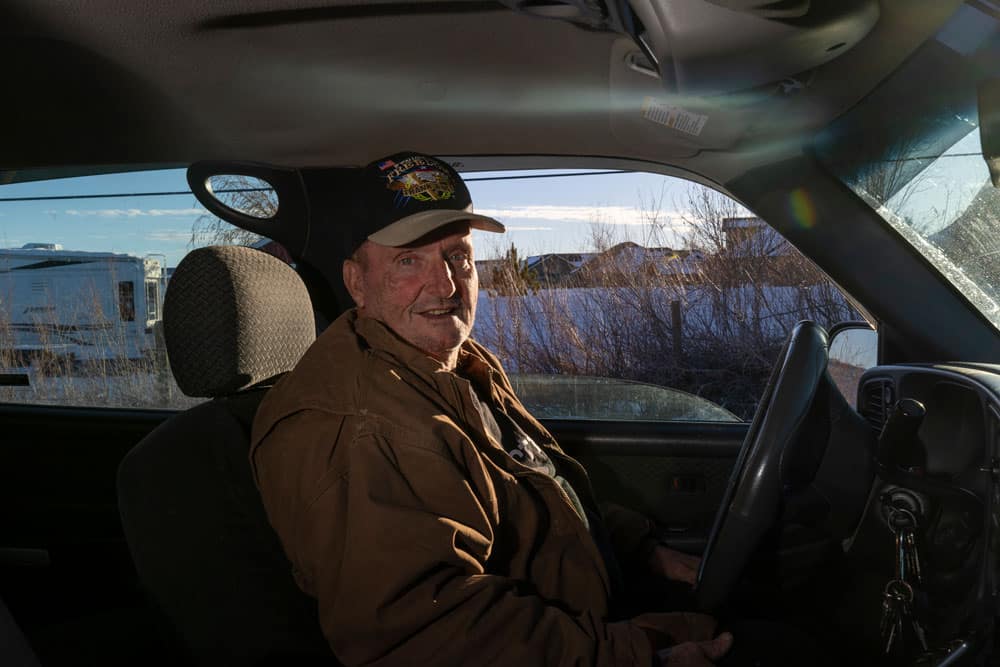 Man sitting in driver seat of car.