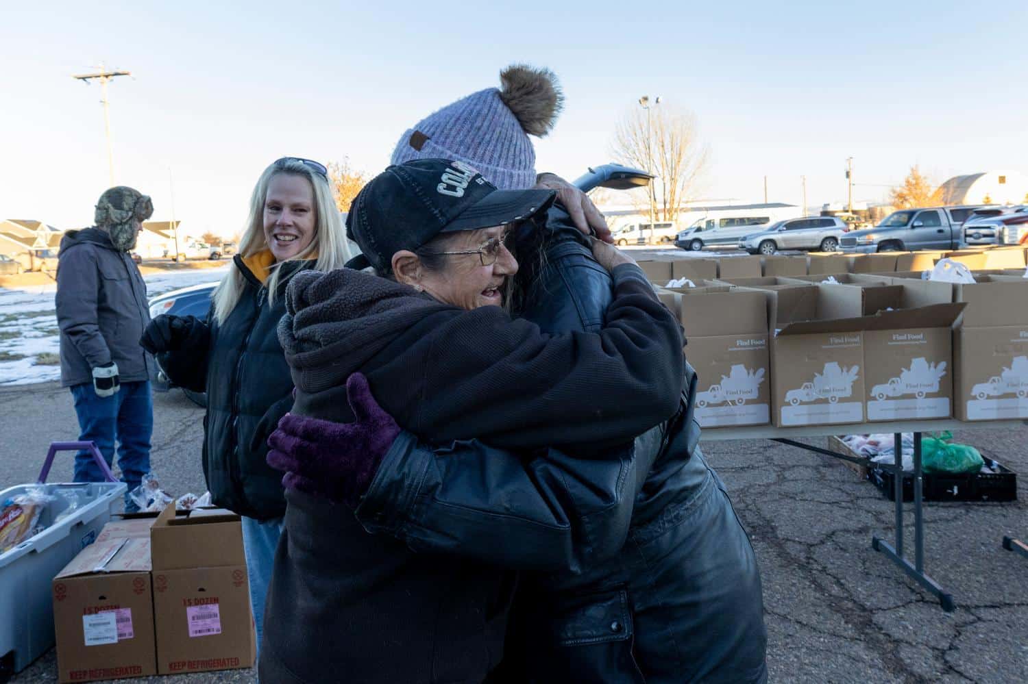 two people hugging outside at a mobile food pantry in Wyoming