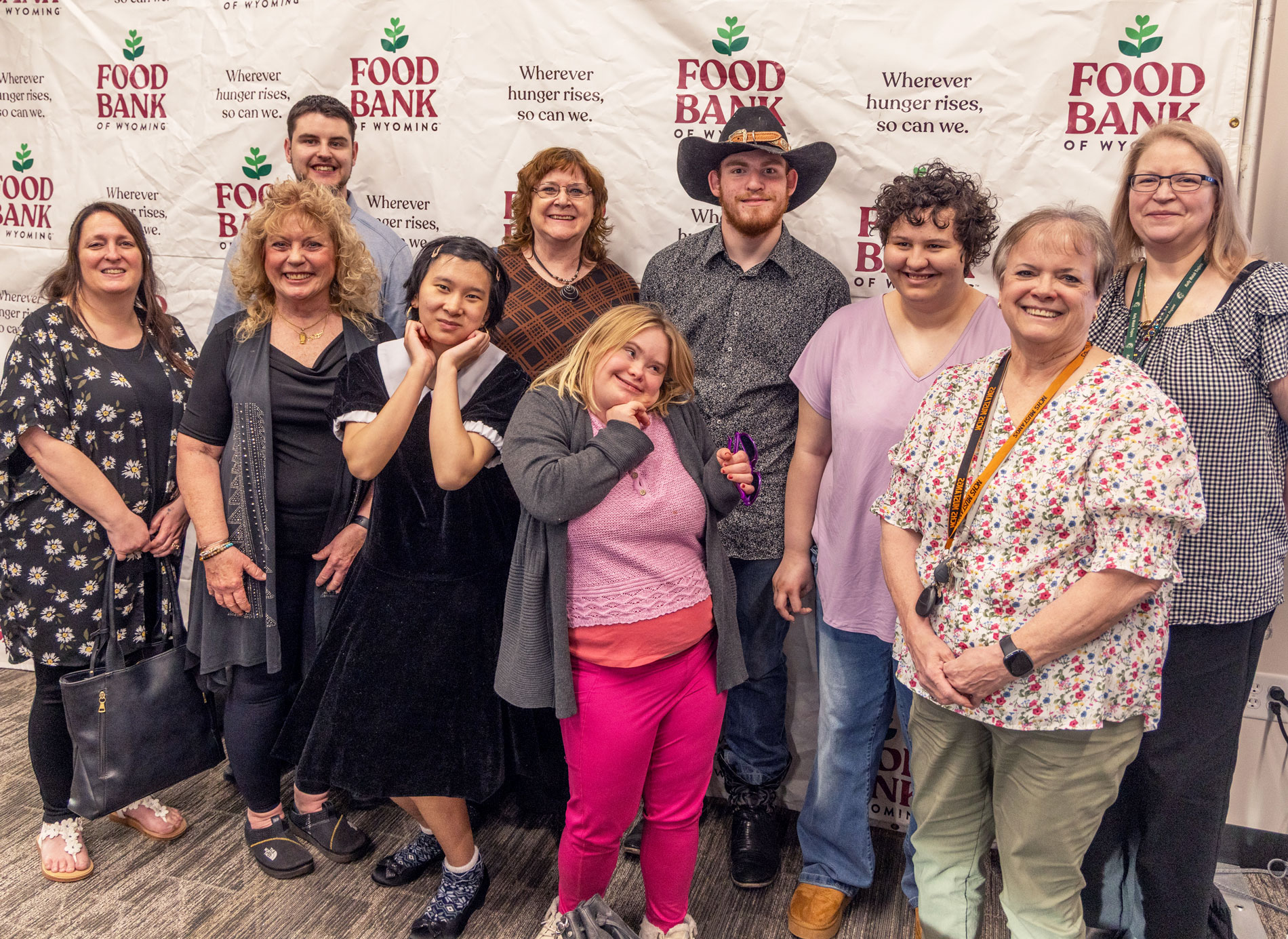 I Reach Group standing in front of Food Bank of WY backdrop.