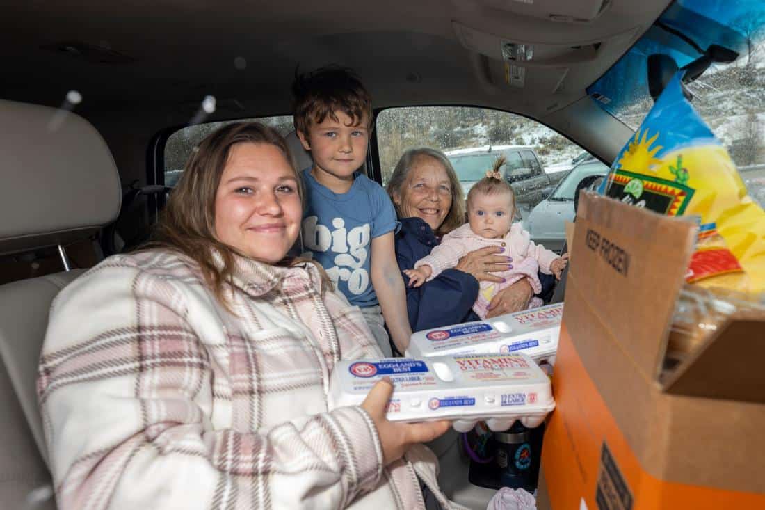 a family in their car holding the food they received from a mobile food pantry in Wyoming